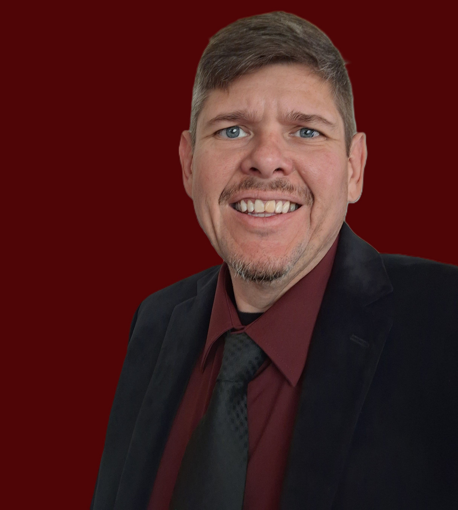 Tony Ward – Christian Author Tony Ward smiling in a suit and tie, Christian author and speaker